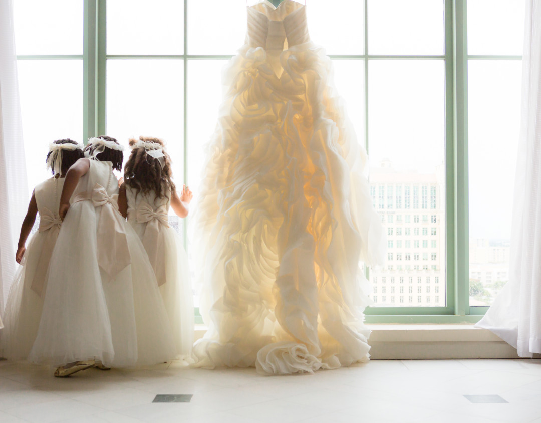 Flower girls next to dress Photojournalism by Alfredo Valentine Couture Bridal Photography for Westin Colonnade Coral Gables Wedding