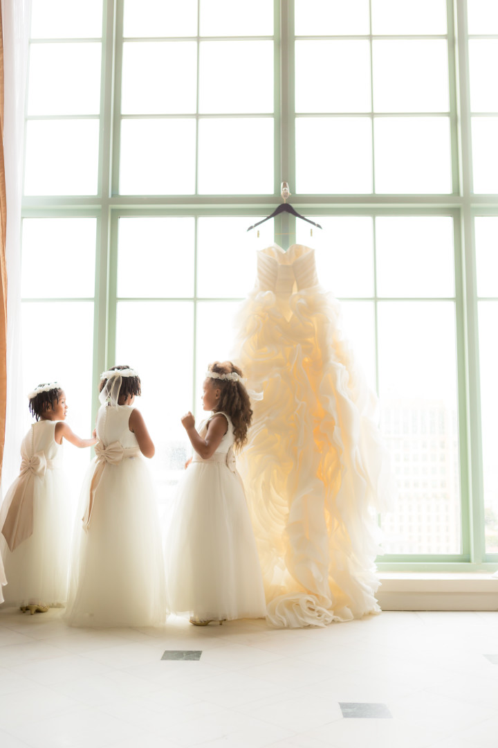 Flower girls next to dress Photojournalism by Alfredo Valentine Couture Bridal Photography for Westin Colonnade Coral Gables Wedding