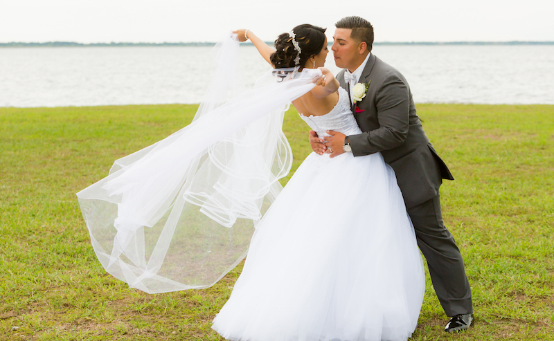 Couture Bridal Photography is an Orlando Wedding Photographer and captured this image of a bride and groom on the lake in an embrace 
